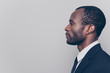 © deagreez - Side profile view portrait of smart experienced qualified clever strict head on big company clothed in black jacket and white shirt looking aside isolated on gray background copyspace