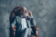 © deagreez - Portrait of posh classy chic elegant rich stunning luxurious millionaire sharp-dressed with maroon pocket tissue relaxing on leather armchair holding cigarette and whisky isolated on grey background
