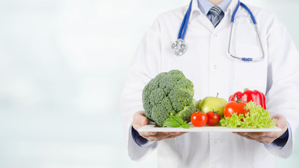 Doctor holding vegetables and fruits on a tray