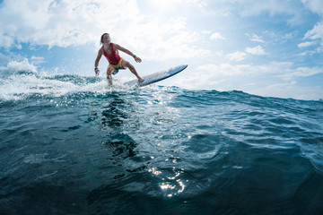 Wall Mural - Surfer rides the ocean wave