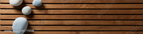 zen pebbles set on design wooden board, top view banner Wallpaper Mural
