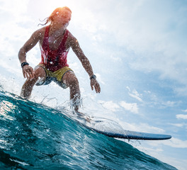 Wall Mural - Young surfer rides the ocean wave