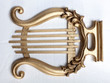 © Showtime Networks - Gold colour antique mouth harp, white background