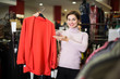 © JackF - Woman choosing knitwear cardigan