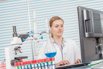 Poster - Experiments in the chemical laboratory, Female researcher using her test tube in a laboratory