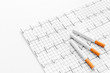 © 9dreamstudio - Danger of smoking. Cigarettes on cardiogram on white background