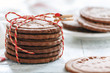 Stack of chocolate cookies tied with a cord.