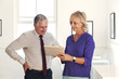 © Strauss/Curtis/Blend Images - Smiling Caucasian man and woman using digital tablet