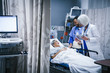 © FS Productions/Blend Images - Doctor and nurse talking with patient in hospital bed