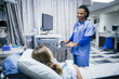 © FS Productions/Blend Images - Nurse talking to patient in hospital bed