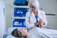 Caucasian Doctor Comforting Patient Near Scanner