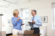 © Strauss/Curtis/Blend Images - Caucasian businessman and businesswoman drinking coffee
