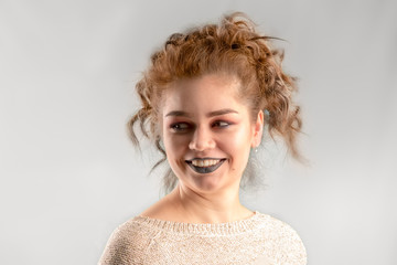 Caucasian smiling beautiful woman with curly hair on white background.