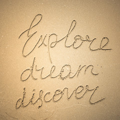 Wall Mural - Explore Dream Discover word is written on the beach sand