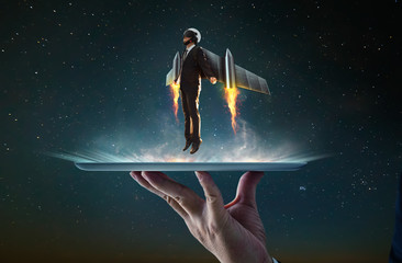 waiter hand holding an empty digital tablet with businessman wear a rocket suit to lift , business s