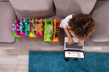 Wall Mural - Happy Young Woman Using Laptop