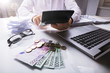 © Andrey Popov - Businessman Using Calculator With Euro Currencies