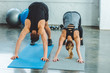 © LIGHTFIELD STUDIOS - couple stretching on mats together in gym