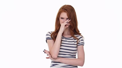 Poster - Sad redhead young illness lady isolated over white wall background sneezes