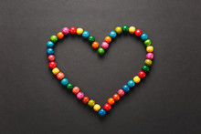 Colorful Wooden Beads In The Form Of Heart Isolated On Black Background For Design. Saint Valentine's Day Card On Fabruary 14, Holiday Concept. Copy Space For Advertisement.