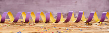 Ribbon With Scattered Confetti On Wooden Surface