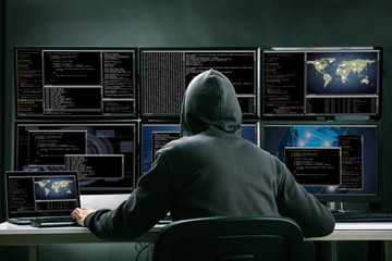 Wall Mural - Hacker Using Multiple Computers For Stealing Data