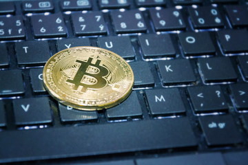 Wall Mural - golden bitcoin coin on computer keyboard, cryptocurrency bitcoin mining concept