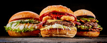 Close-up Of Three Different Hamburgers On Table