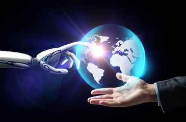 human and robot hand with virtual earth hologram