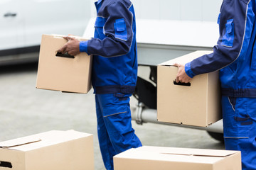 Wall Mural - Two Men Holding The Cardboard Boxes