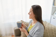 © Syda Productions - happy woman drinking tea or coffee at home