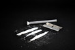 Cocaine line on a black background. Drugs still life. Drug, blade and snort tube. Drug accessories