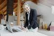 © epiximages - young, pretty, blonde architect is planning on the notebook and tablet the expansion of a loft