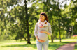 © Syda Productions - happy pregnant asian woman walking at park