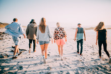 Group Of Friends Walking On The Beach