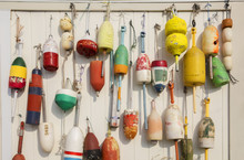 Colorful Buoys Hanged On Wooden Wall. Lobster Buoys On The Wall Of The Barn