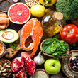 Balanced diet food background. Fish, leguminous, vegetables, fruit, seed and nuts. Top view.