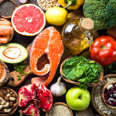 Wall Mural - Balanced diet food background. Fish, leguminous, vegetables, fruit, seed and nuts. Top view.