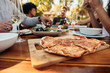 © Jacob Lund - Pizza on dining table with friends