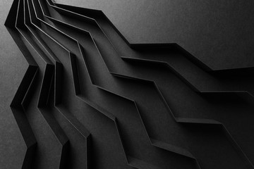 Abstract pattern made of black paper, dark background	