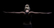 © Alta Oosthuizen - Beautiful fit and healthy blond woman in black top in dark with arms stretched from behind