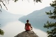 © Wavebreak Media - Fit woman sitting in meditating posture on the edge of a rock