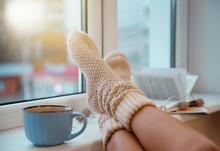 Woman In Woollen Socks Relaxing At Home