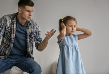 Wall Mural - Man scolding his daughter at home