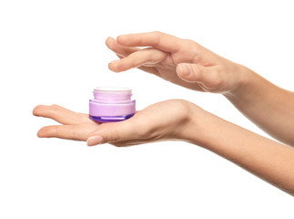 Poster - Young woman holding jar of hand cream on white background