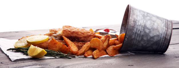 traditional British fish and chips with potato and lemon