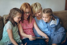 Mother And Kids Using Digital Tablet At Home