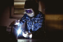  Worker Working On Manufactured Metal Parts 