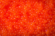 Raw salmon/trout fish eggs. Close up red caviar sea food pattern