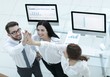 © ASDF - successful business team giving each other a high five .
